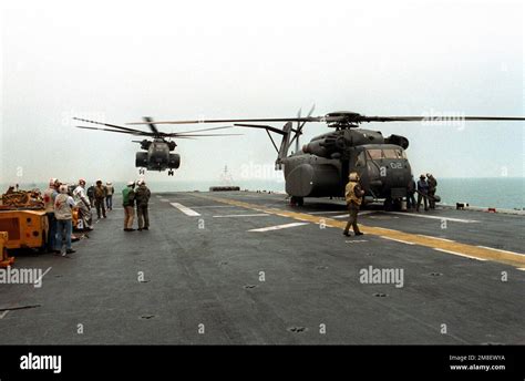 Flight Deck Crewmen Gather Around An Mh E Sea Dragon Helicopter