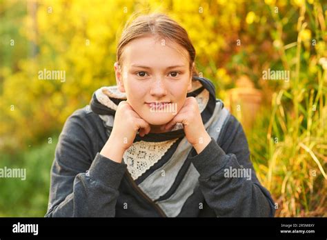 Outdoor Close Up Portrait Of Young Teen Girl Leaning Head On Hands