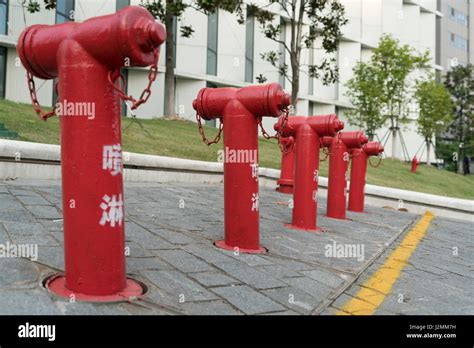 A Group Of Red Fire Water Hydrant Beside The Building Stock Photo Alamy