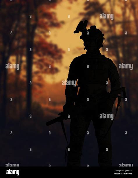 The silhouette of a military soldier with weapons at sunset Stock Photo ...