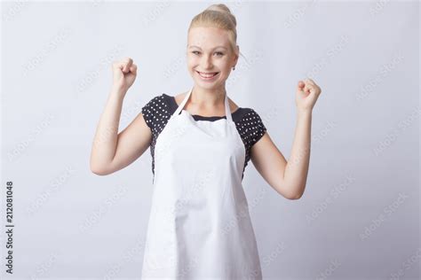 Cute Blonde Woman In White Apron Posing On White Background Cook A Housewife Stock Photo