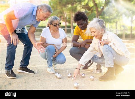 Positive Mature Diverse Percioners Comparing The Distance Of Pumped Balls After Petangue At The