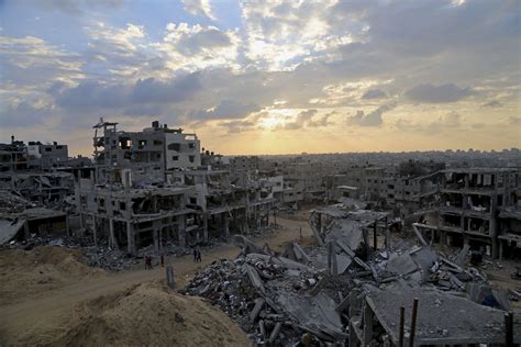 In This Oct 12 2014 File Photo Palestinians Walk Between The Rubble