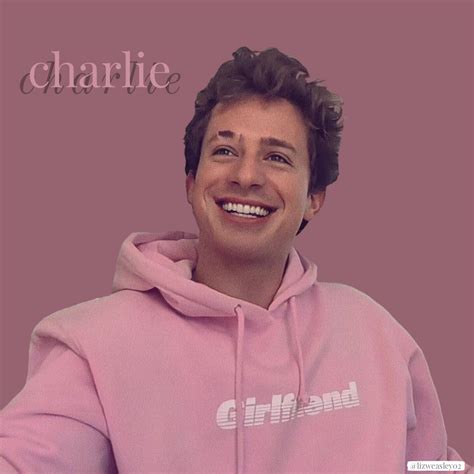 a smiling man in a pink hoodie with the words charlie written on his chest