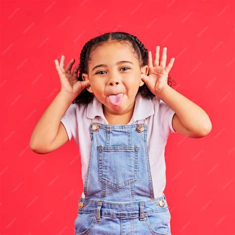 Premium Photo | Child portrait and tongue out on isolated red ...