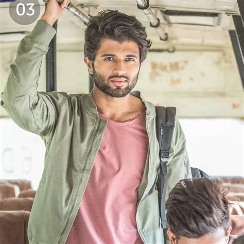 A Man Is Holding His Head In The Air While Standing On A Bus With