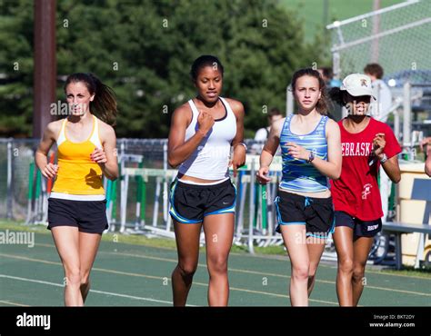 Four Teenage Girls Running On A High School Track Girls High School