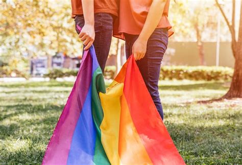 Premium Photo A Lesbian Female Couple Holding A Lgbtq Rainbow Flag