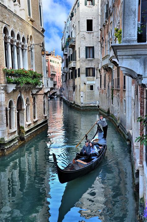 Romantic Couple In Gondola On Canal In Venice Italy Encircle Photos