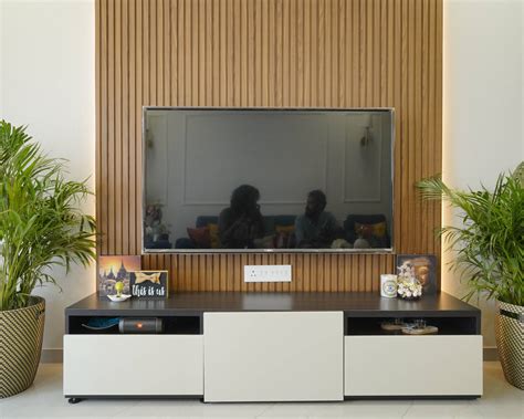 White TV Unit With Wooden Planks On The Back Wall Livspace