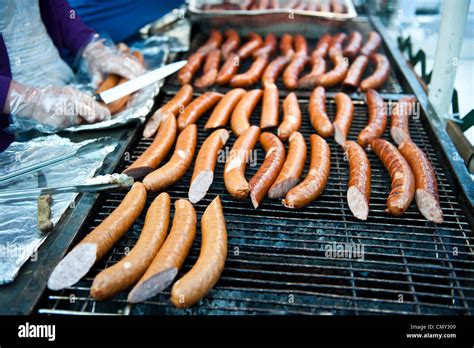 Cook Slicing Hot Dogs Before Placing Them On The Grill Stock Photo Alamy