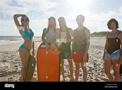 Friends hanging out on a beach Stock Photo - Alamy