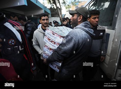 Displaced Palestinians Receive Food Aid At The United Nations Relief