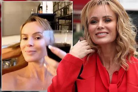 BGT babe Amanda Holden shows off pert derrière as she takes the bins