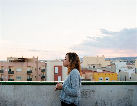 Woman On The Balcony Of Her House With Buildings Views By Stocksy Contributor Susana Ramírez