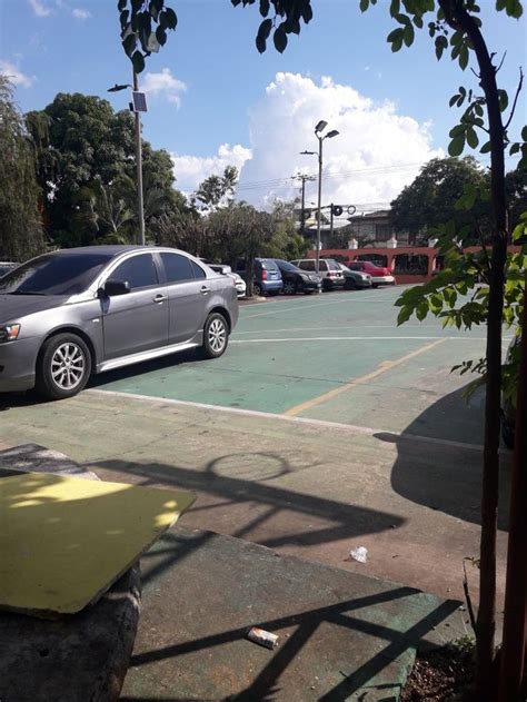 An Empty Parking Lot With Cars Parked In It