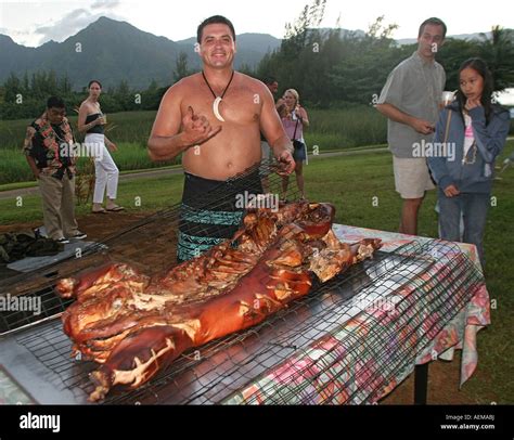 Hawaiian man with pig cooked in imu pit oven for luau Kauai HI Stock Photo - Alamy