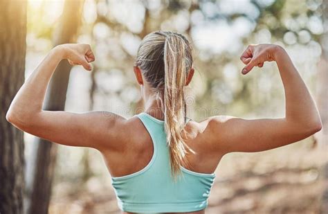 Woman Can Flex Too A Young Woman Flexing Her Arms Outdoors Stock