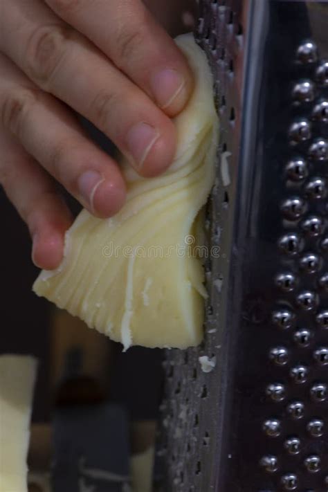 Close Up Of Womanand X27s Hand Grating Cheese On The Metal Grater Stock