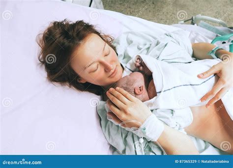 Mother Holding Her Newborn Baby After Labor In A Hospital Stock Image