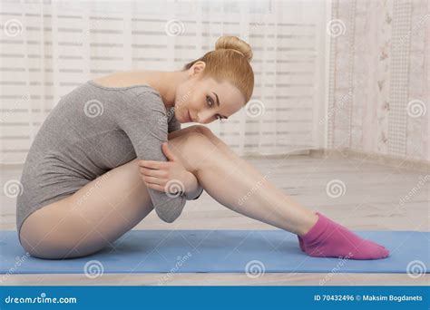 Beautiful Blonde Woman Practicing Yoga Stretching At Home On Blue Mat