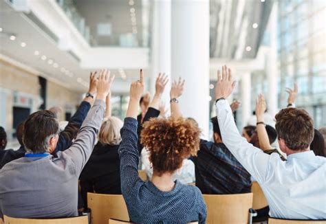 280 Young Businesswoman From Audience Raising Hand To Ask Question