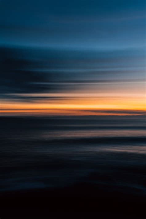 An Orange And Blue Sunset Over The Ocean