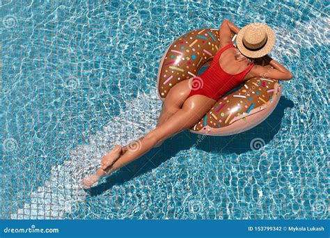 Woman In Bikini Enjoying Summer Sun And Tanning During Holidays In Pool