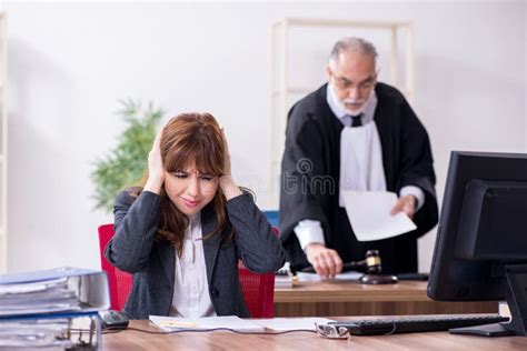 Old Male Judge And His Young Secretary In The Office Stock Photo