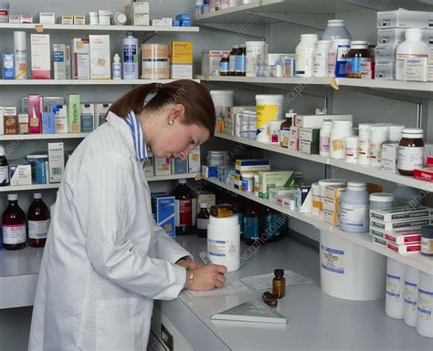 A Pharmacist Filling In A Prescription Stock Image M6400106