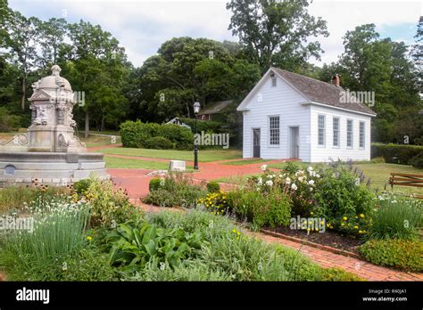 Fountain, gardens, and schoolhouse at the Long Island Museum of Art, History, and Carriages ...