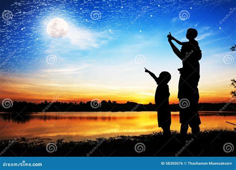 Silhouette Of Father Use Hand Point His Son Look At Full Moon Royalty