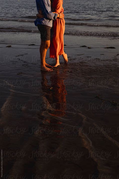 "Couple Hugs At The Beach At Sunset" by Stocksy Contributor "Mauro Grigollo" - Stocksy