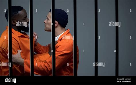 Caucasian prisoner fighting with black inmate, discrimination, jail ...