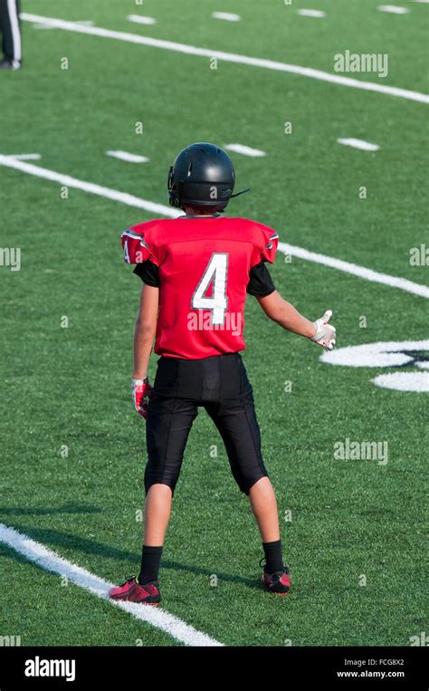 Teenage american football player giving a thumbs up on the field during ...