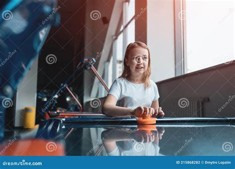 Beautiful Brunette Female Playing Air Hockey With Friend Stock Photo Image Of Happy