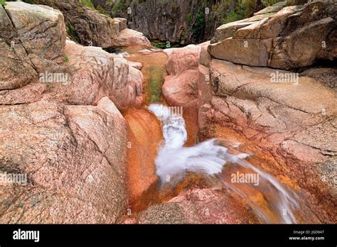 Small Waterfall In Mountain Ravine With Huge Rocks Stock Photo Alamy