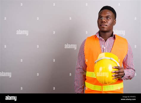 Young African Man Construction Worker Against White Background Stock