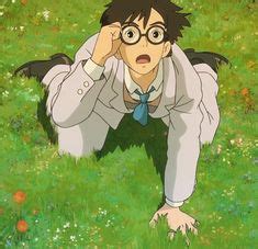 A Man With Glasses And A Tie Is In The Grass Looking At Something While