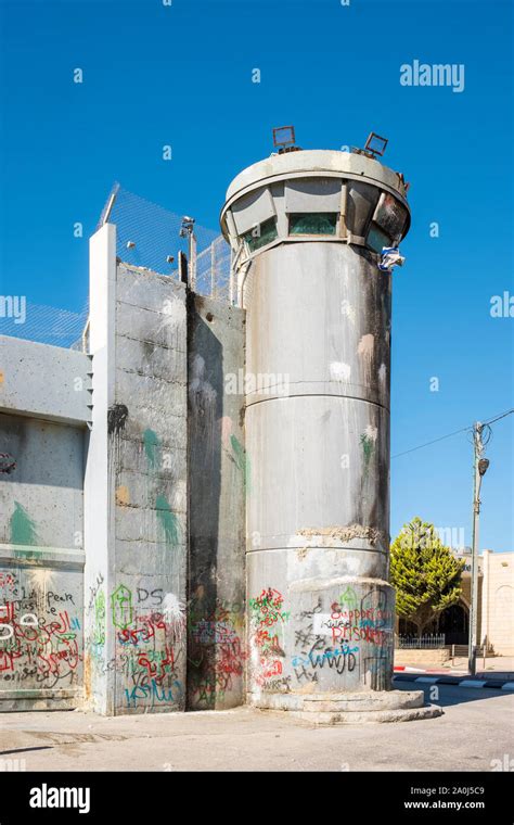 Palestine, West Bank, Bethlehem. A lookout tower covered in graffiti ...