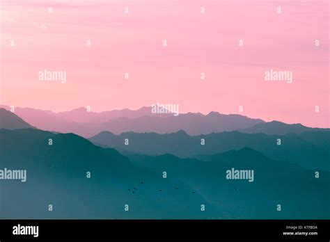 Mountain range at sunrise light Stock Photo - Alamy