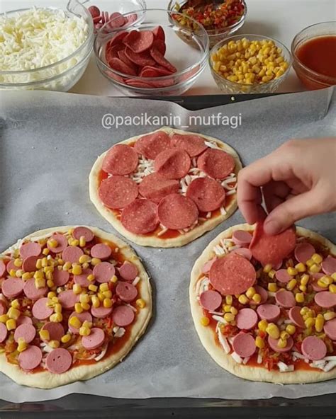 Two Pizzas With Pepperoni Corn And Sausage On Them Are Being Prepared