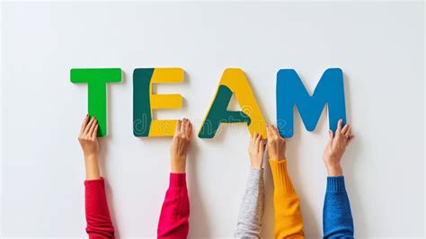 teamwork concept hands holding colorful letters spelling team stock