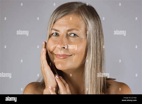 Caucasian Mature Lady Touching Gently Her Cheek Smiling And Looking At Camera Beautiful