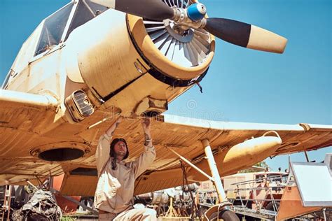 Mechanic in Uniform and Flying Helmet Repair Retro Military Airplane in ...