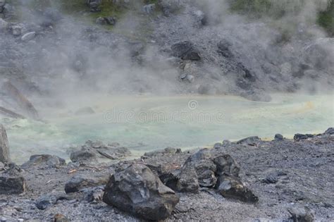 Acidic Hot Spring Stream Water With Hydrochloric Acid Emitting Steam In Mountain Valley At