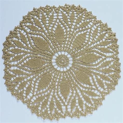 A Crocheted Doily Is Shown On A White Surface