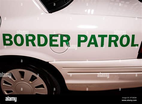 Customs And Border Patrol Logo On The Side Of The White Patrol Car