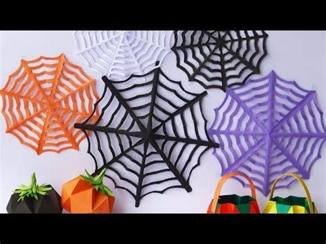 halloween decorations made out of paper and spider webs