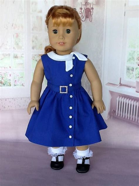 The Doll Is Wearing A Blue Dress And Black Shoes